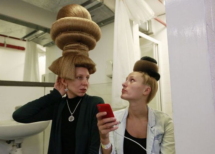 Models for hair stylist Mario Krankl wait backstage at the 30th anniversary of the Alternative Hair Show at the Royal Albert Hall in London